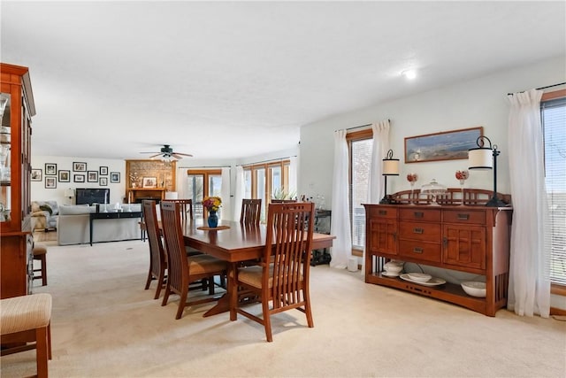 carpeted dining space featuring ceiling fan