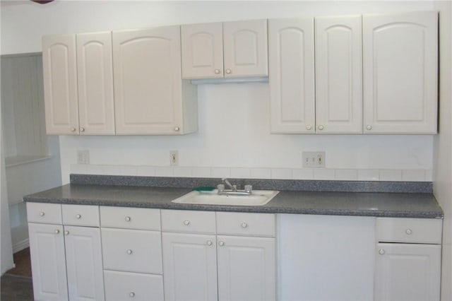 kitchen featuring white cabinetry and sink