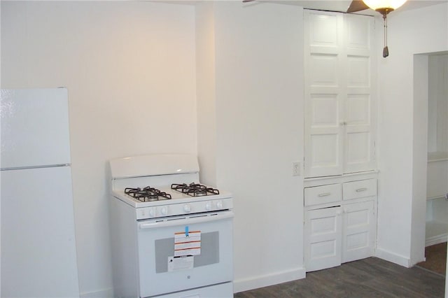 kitchen featuring dark hardwood / wood-style flooring and white appliances