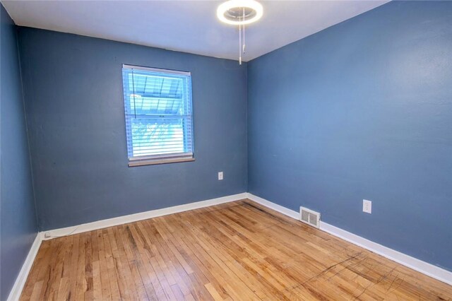 spare room with hardwood / wood-style flooring