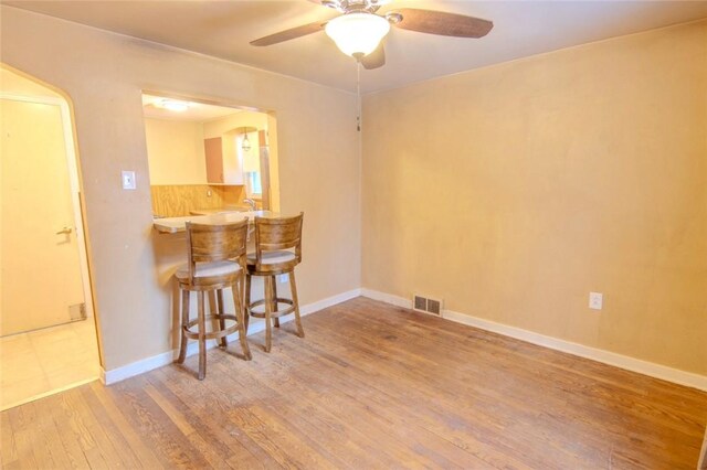 unfurnished room with ceiling fan and light hardwood / wood-style flooring