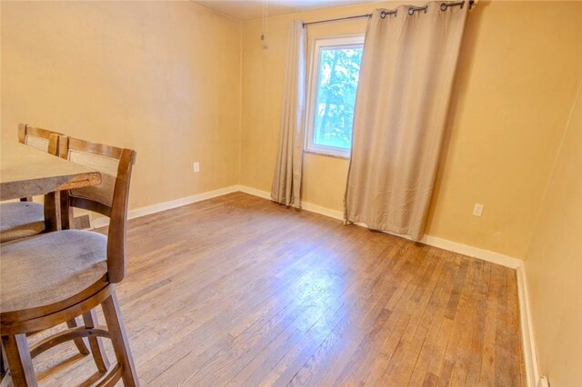 dining space with hardwood / wood-style flooring