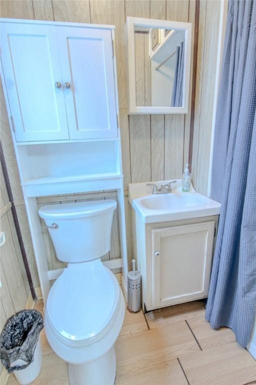 bathroom featuring hardwood / wood-style floors, vanity, and toilet