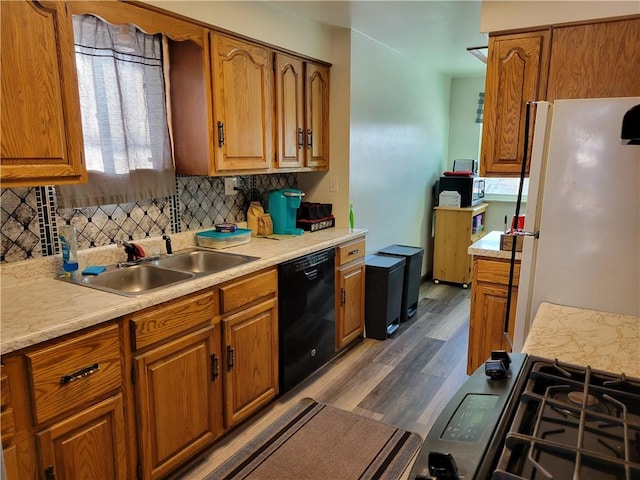 kitchen featuring sink, white refrigerator, dark hardwood / wood-style floors, dishwasher, and backsplash