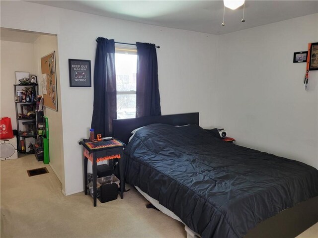 bedroom featuring light colored carpet