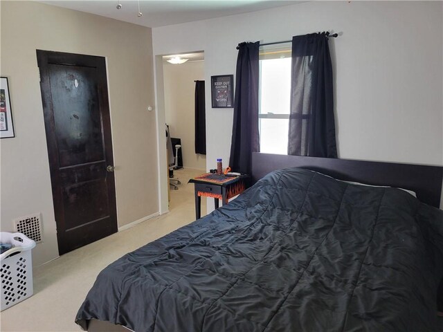 bedroom featuring light carpet