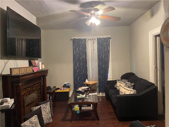 living room featuring dark hardwood / wood-style floors and ceiling fan