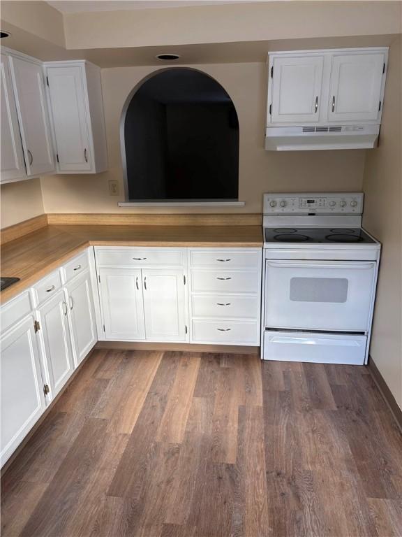 kitchen featuring white cabinetry, dark wood-type flooring, and white electric range