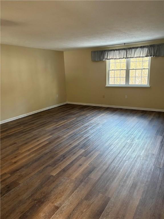 unfurnished room featuring dark hardwood / wood-style floors