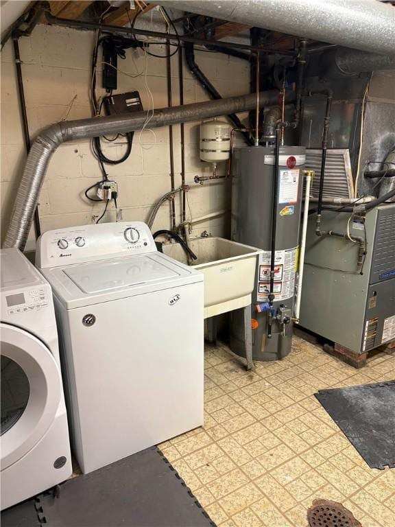 washroom featuring sink, separate washer and dryer, heating unit, and water heater