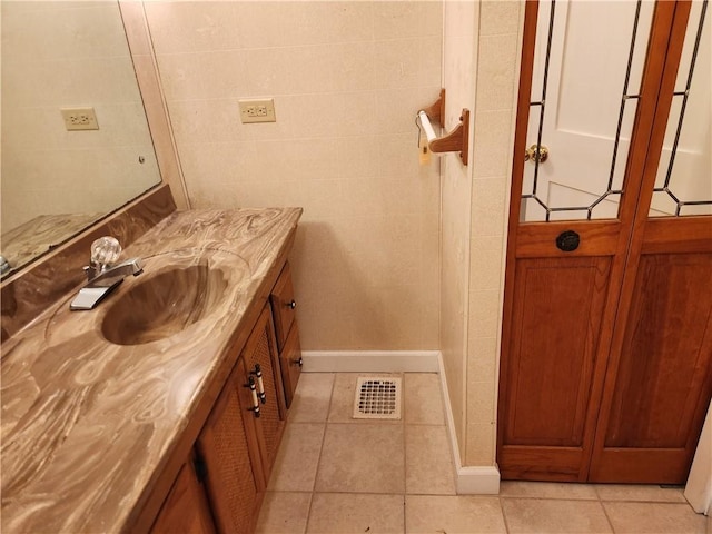 bathroom featuring tile patterned flooring and vanity