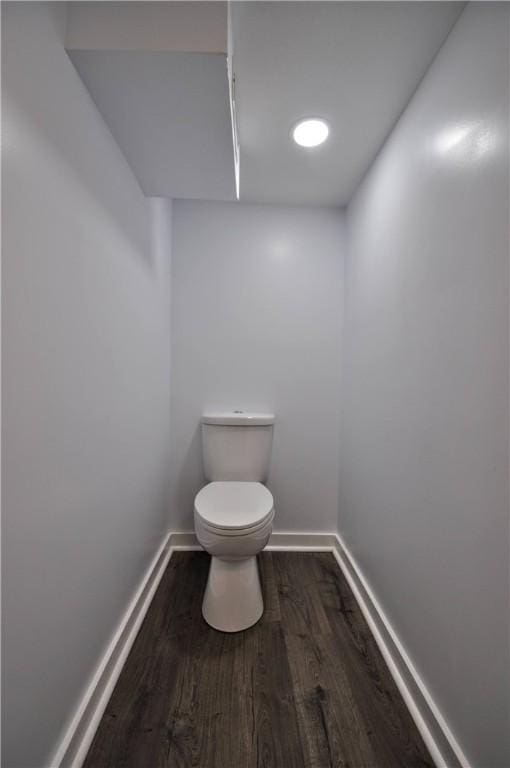 bathroom featuring wood-type flooring and toilet