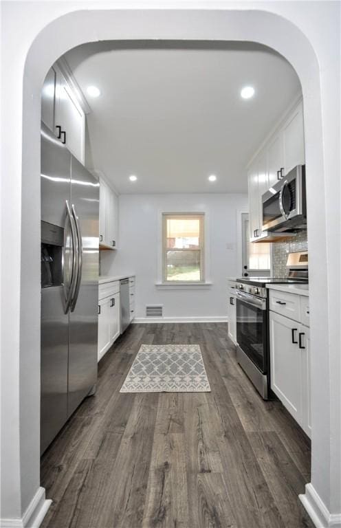 kitchen featuring white cabinetry, dark wood-type flooring, and appliances with stainless steel finishes