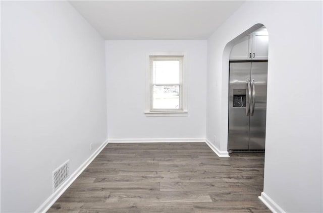 unfurnished dining area featuring wood-type flooring