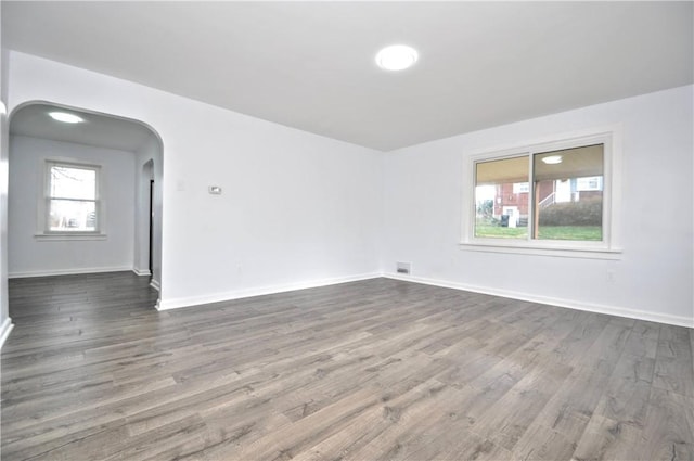 unfurnished room featuring dark hardwood / wood-style floors