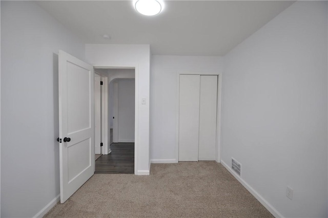 unfurnished bedroom with a closet and carpet