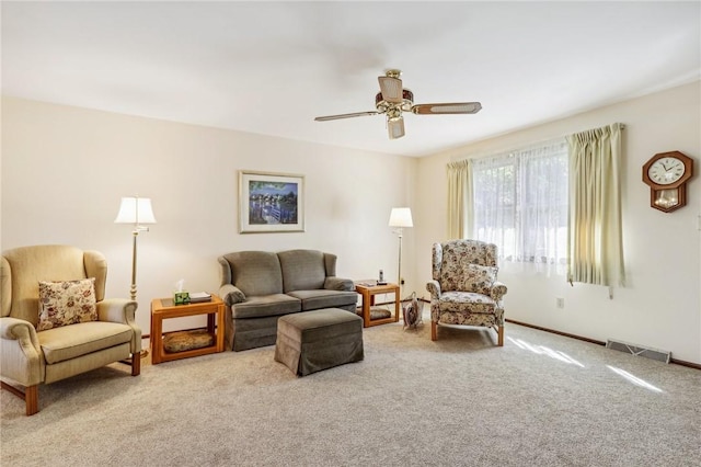 carpeted living room featuring ceiling fan