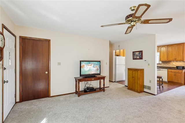 living room with light carpet and ceiling fan