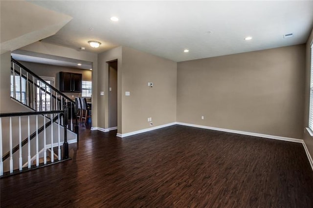 unfurnished room with dark wood-type flooring