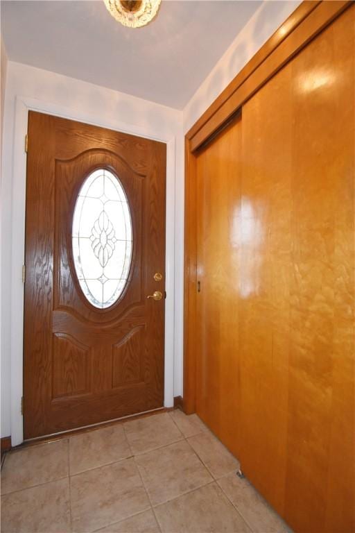 entryway with light tile patterned flooring