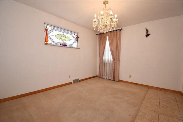 unfurnished room with a chandelier