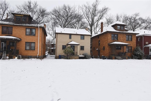 view of snow covered rear of property