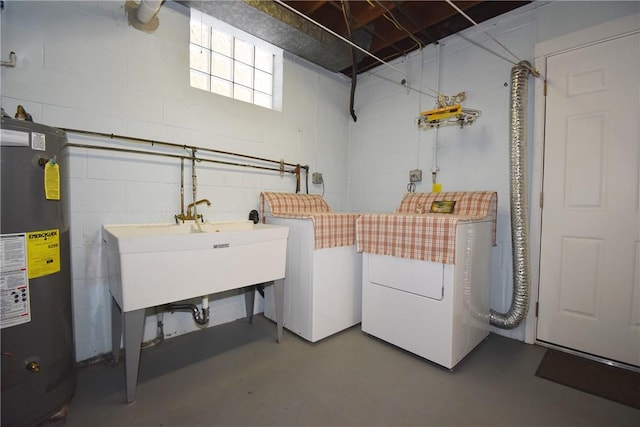 clothes washing area with sink, gas water heater, and washing machine and clothes dryer