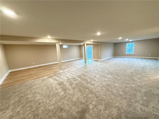 below grade area featuring carpet and baseboards