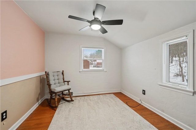 living area with wood-type flooring, vaulted ceiling, and ceiling fan