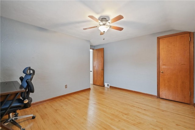 unfurnished office featuring light hardwood / wood-style floors and ceiling fan