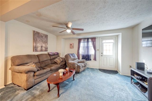 living room featuring carpet flooring, a textured ceiling, and ceiling fan