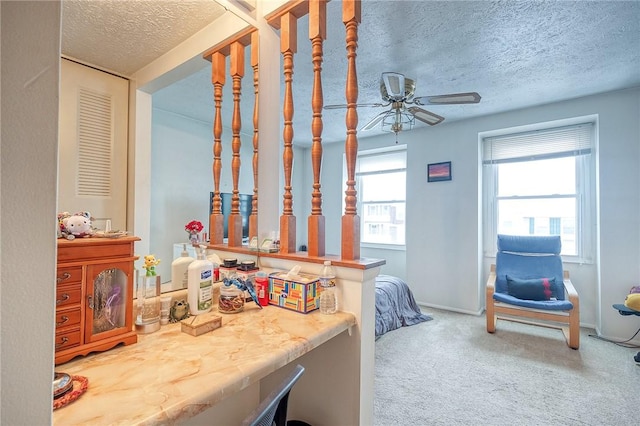 bedroom with carpet, ceiling fan, a textured ceiling, and multiple windows