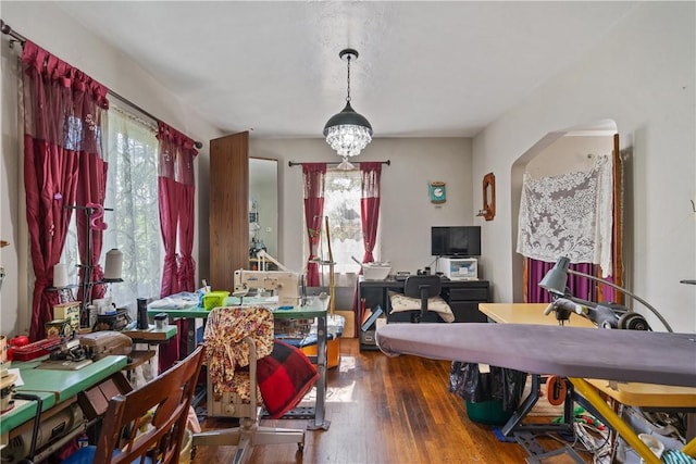 dining area with hardwood / wood-style floors and a notable chandelier