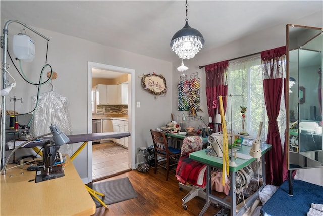 dining area with a notable chandelier and dark hardwood / wood-style floors