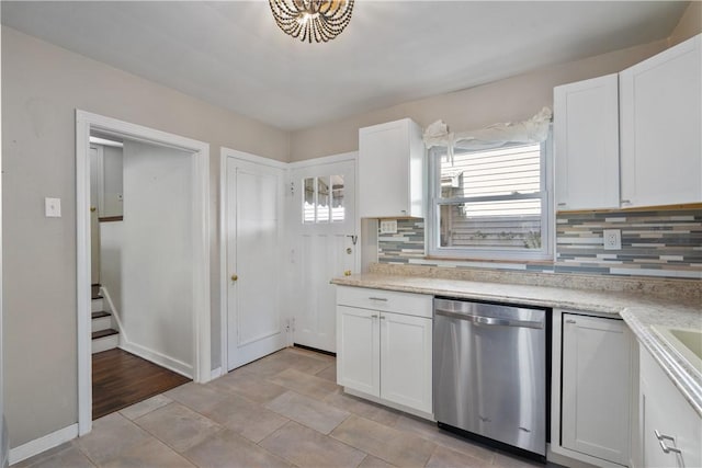 kitchen featuring backsplash, white cabinetry, and stainless steel dishwasher