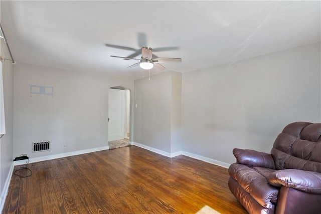 unfurnished room featuring ceiling fan and dark wood-type flooring