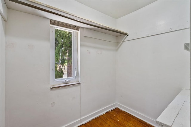 walk in closet with hardwood / wood-style flooring