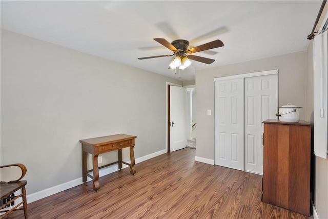 bedroom with ceiling fan, dark hardwood / wood-style flooring, and a closet