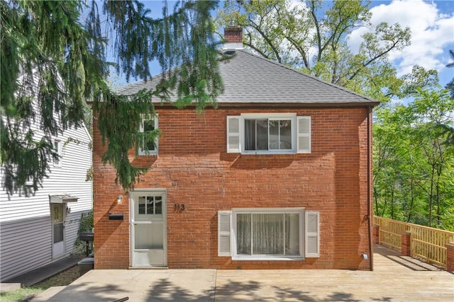 back of house with a wooden deck