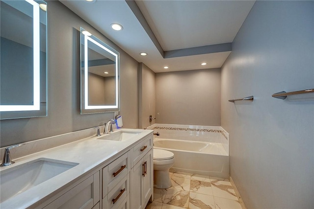 bathroom featuring a washtub, toilet, and vanity