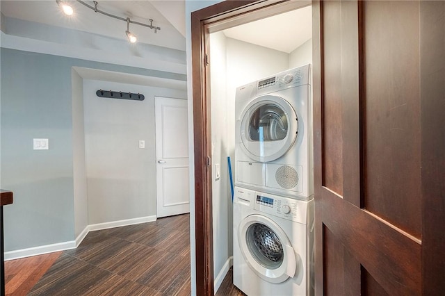 laundry room featuring dark hardwood / wood-style floors and stacked washer / drying machine