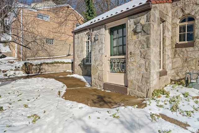 view of snow covered property entrance