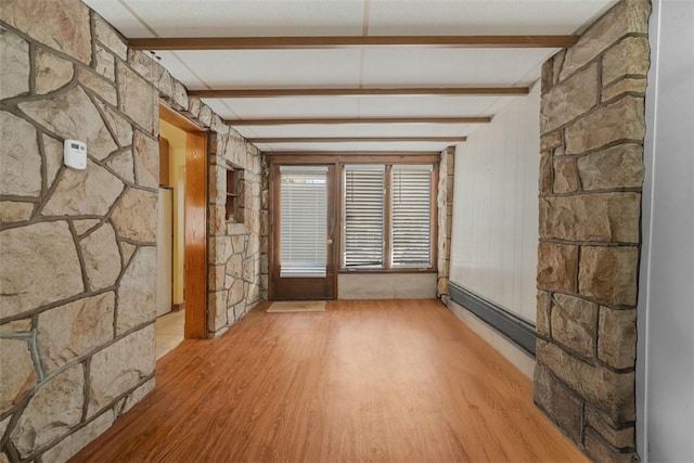 interior space featuring beamed ceiling, a baseboard radiator, and light hardwood / wood-style flooring