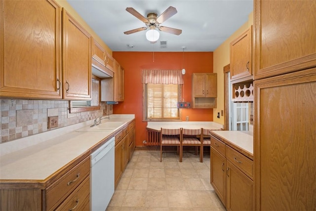 kitchen with backsplash, ceiling fan, sink, decorative light fixtures, and dishwasher