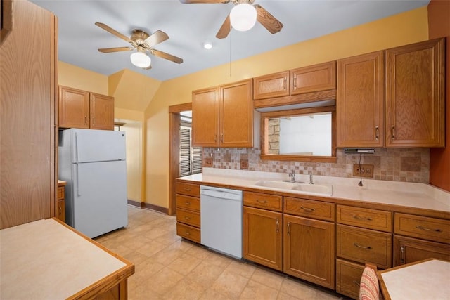 kitchen with ceiling fan, white appliances, sink, and tasteful backsplash