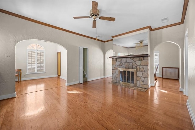 unfurnished living room featuring crown molding, a fireplace, ceiling fan, and hardwood / wood-style floors