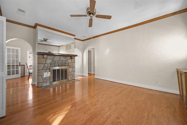 unfurnished living room featuring crown molding, a fireplace, ceiling fan, and hardwood / wood-style flooring