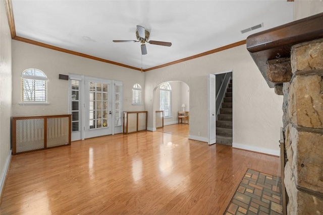 unfurnished living room featuring crown molding, light hardwood / wood-style flooring, and ceiling fan