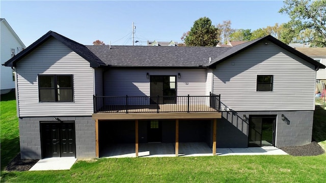 back of house featuring a deck, a yard, and a patio