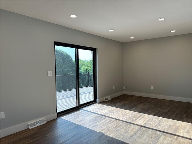 spare room with dark hardwood / wood-style flooring